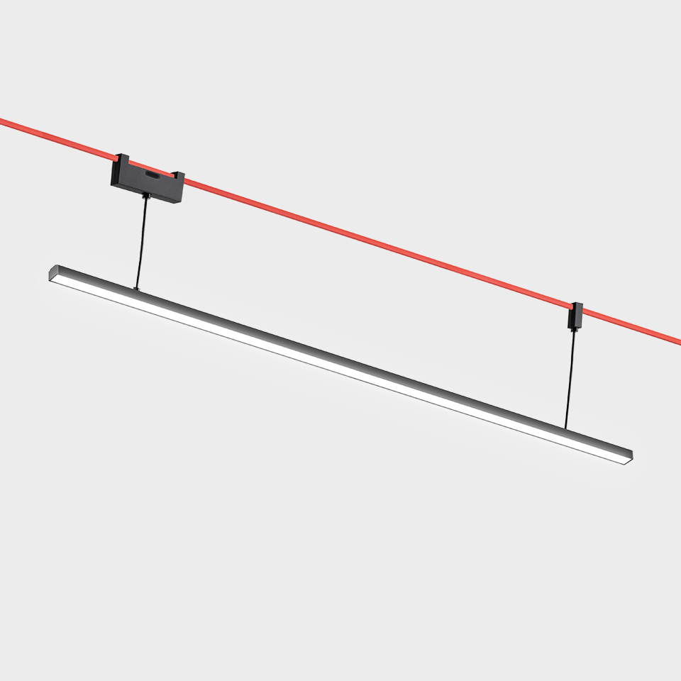 Artemide Funivia linear LED pendant light in dark grey, suspended diagonally from red cable track system with black connectors