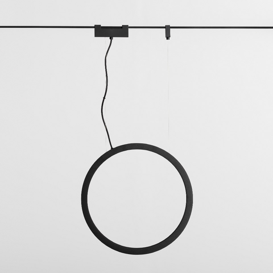 Artemide Funivia pendant lamp: matte black circular LED ring suspended by cable from a ceiling track system