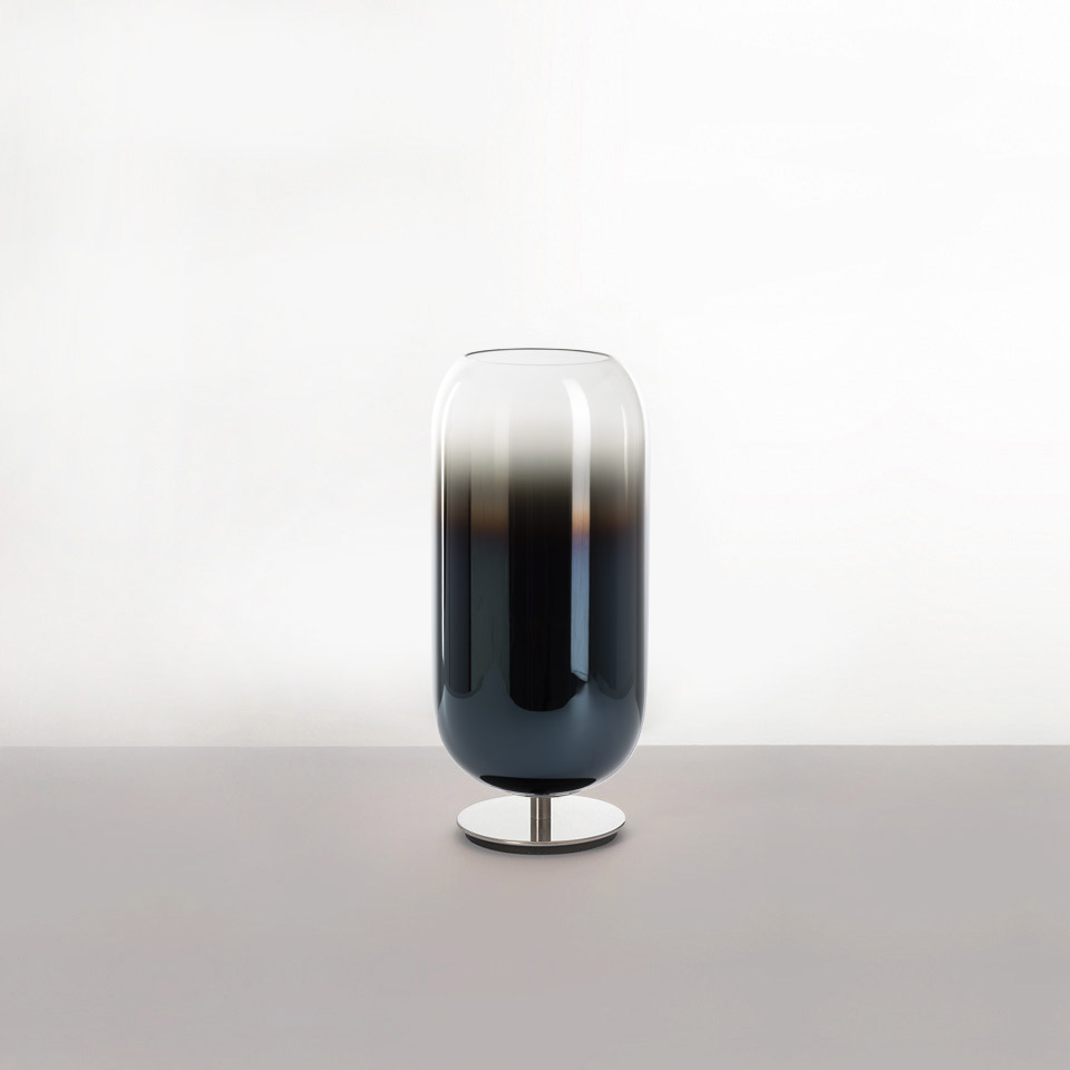 Artemide Gople table lamp: pill-shaped blown glass shade with dark-to-clear gradient, on a polished chrome base