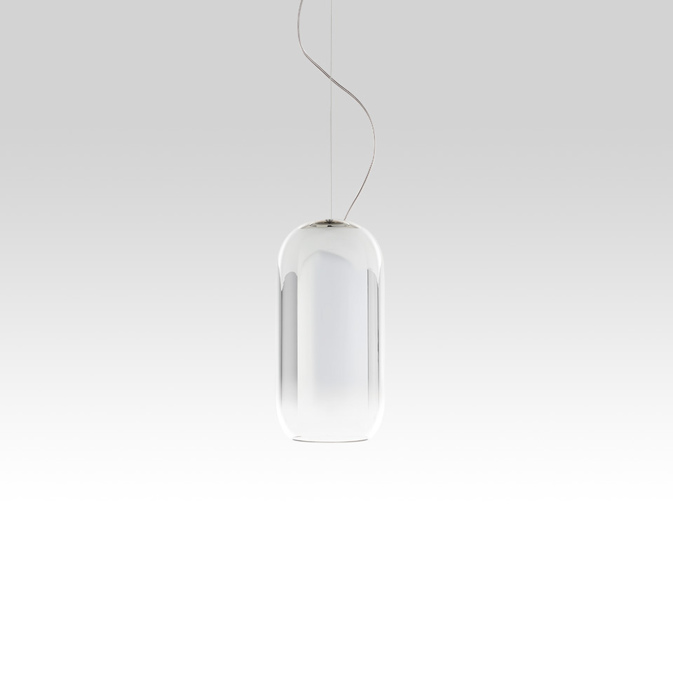 Artemide Gople pendant lamp: elongated capsule-shaped clear and white blown glass diffuser suspended by a thin cable