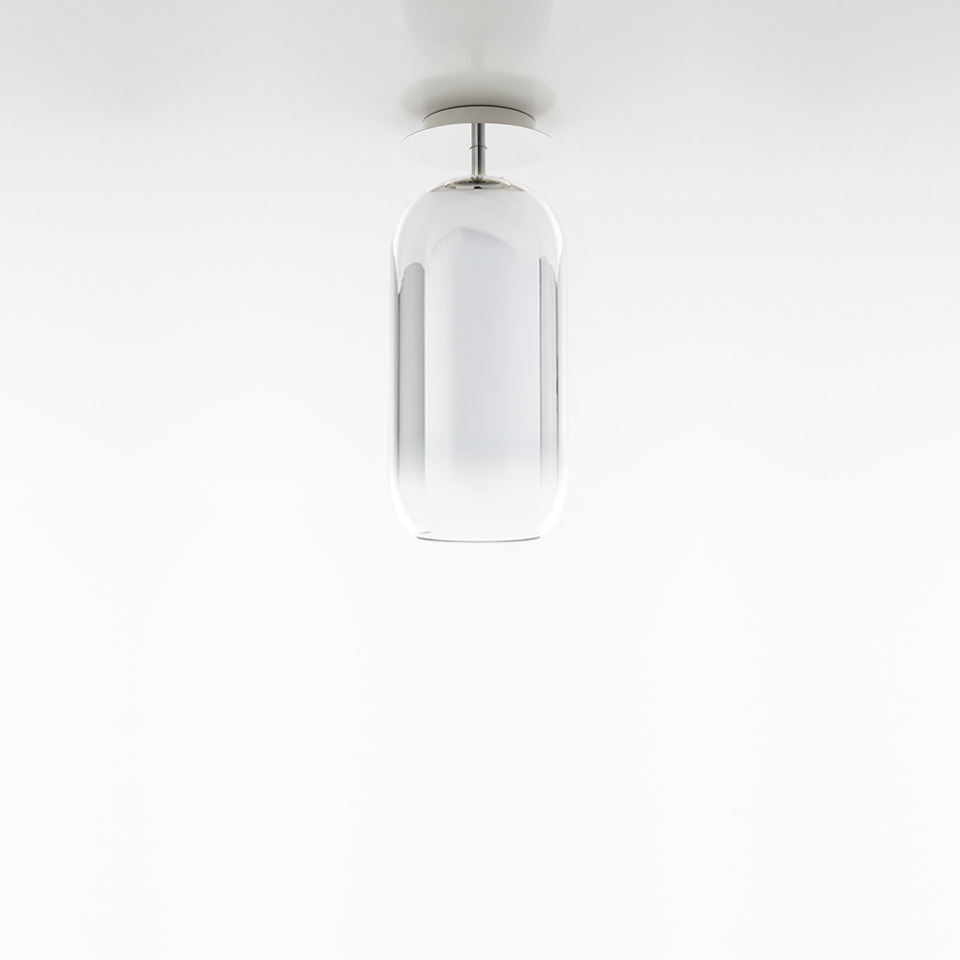 Artemide Gople Mini ceiling lamp with transparent and white blown glass capsule shade, chrome fitting, mounted on white ceiling