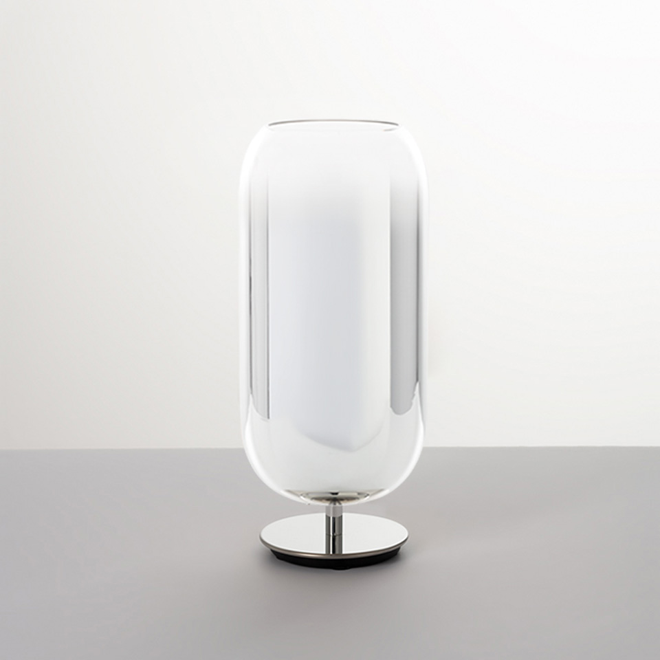 Artemide Gople table lamp: tall transparent glass diffuser with white inner shade on a polished chrome circular base