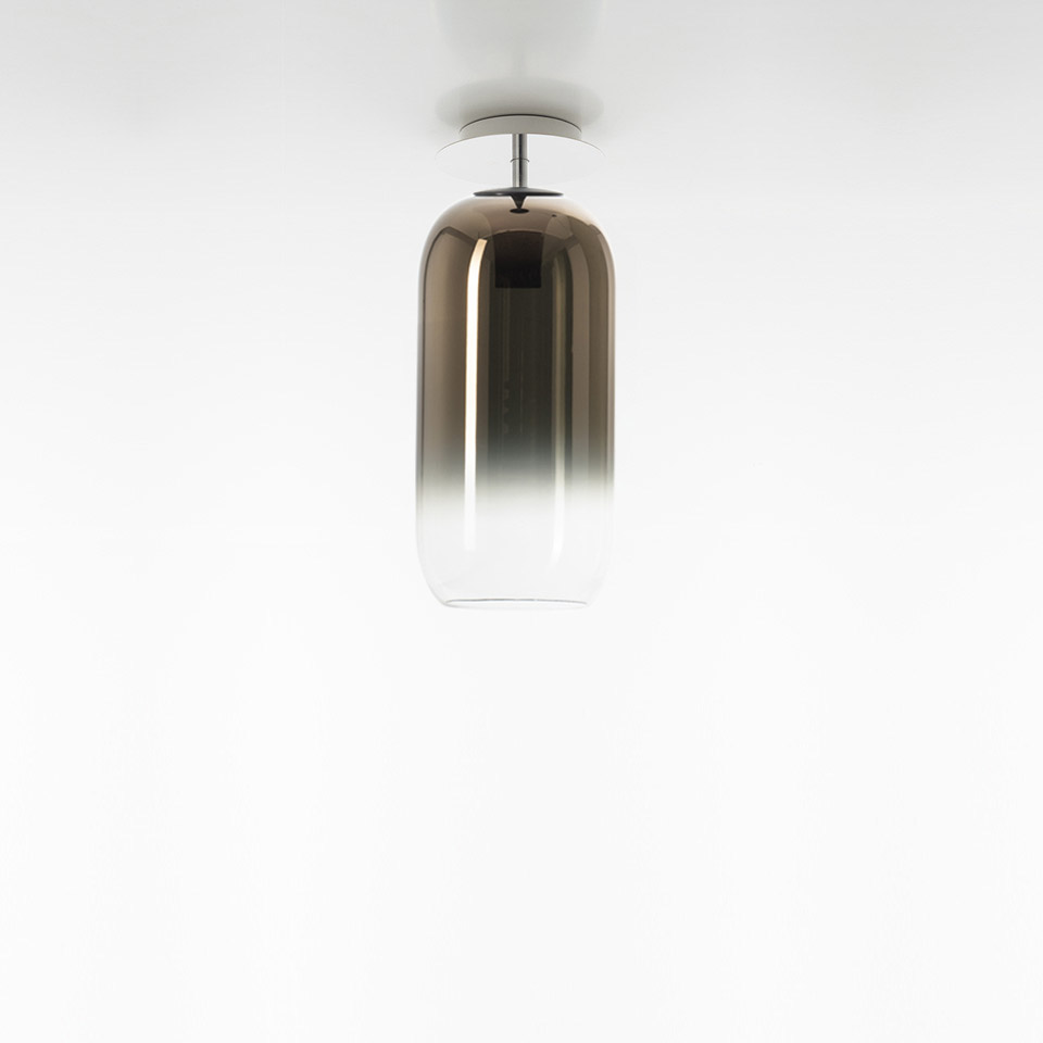 Artemide Gople ceiling lamp with elongated capsule-shaped glass shade, bronze-to-clear gradient finish, chrome ceiling mount