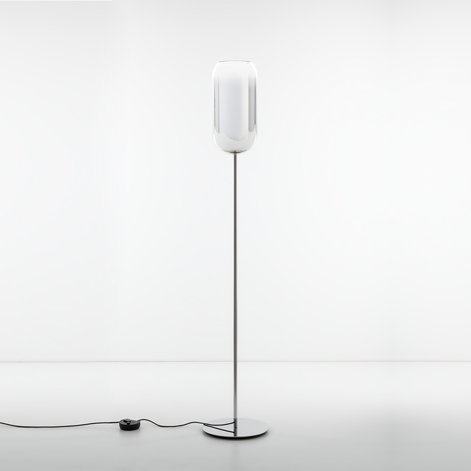 Artemide Gople floor lamp with elongated oval white glass diffuser on a slim chrome stem and round base