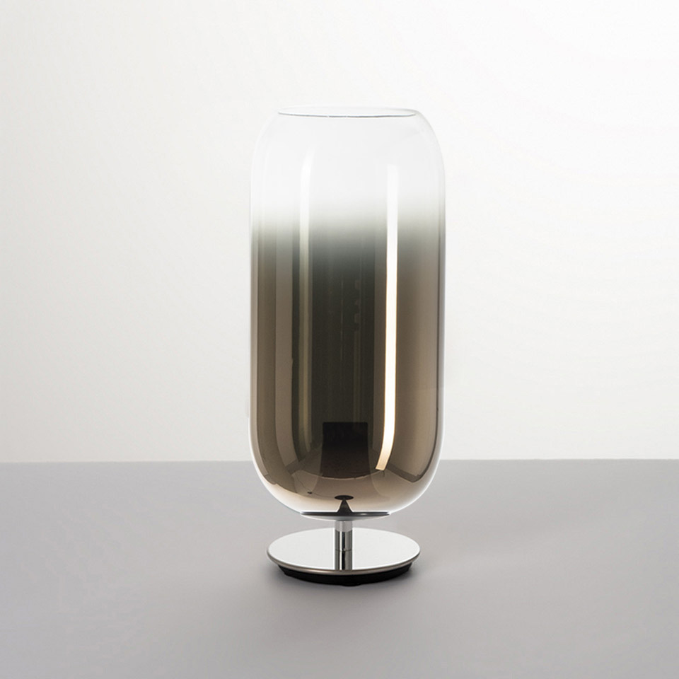 Artemide Gople table lamp: tall capsule-shaped blown glass shade with silver-to-clear gradient, on a polished chrome base