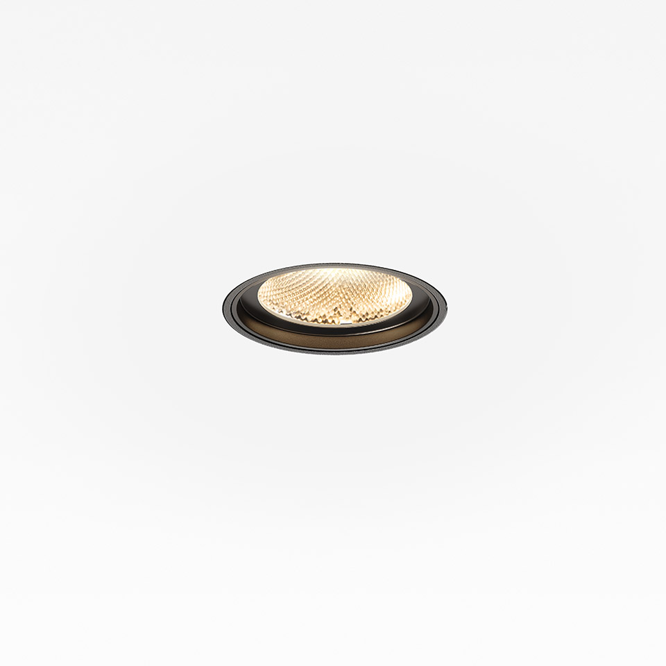 Artemide Hoy Spot recessed ceiling downlight with black circular trim and warm LED light through textured lens