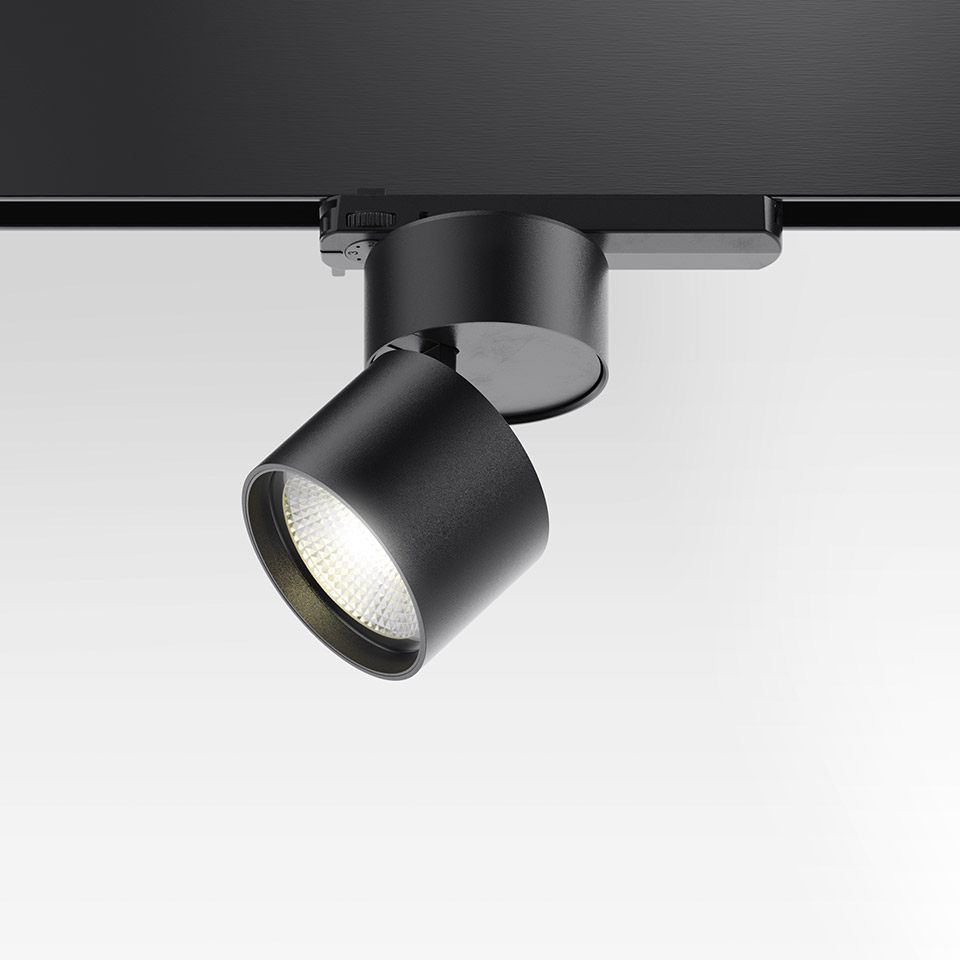 Artemide Hoy Spot 3-Phase Track: black cylindrical LED spotlight mounted on black track rail, tilted at an angle