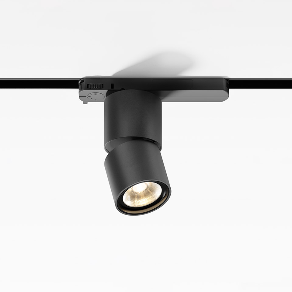 Artemide Hoy Spot 3-Phase Track: black cylindrical adjustable LED spotlight mounted on a black three-phase rail system