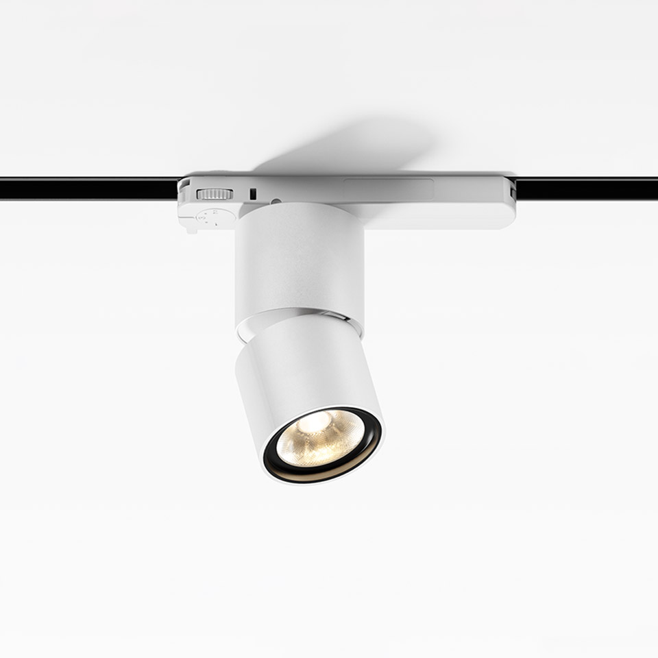 Artemide Hoy Spot 3-Phase Track: white adjustable LED track spotlight mounted on black rail, cylindrical body angled downward