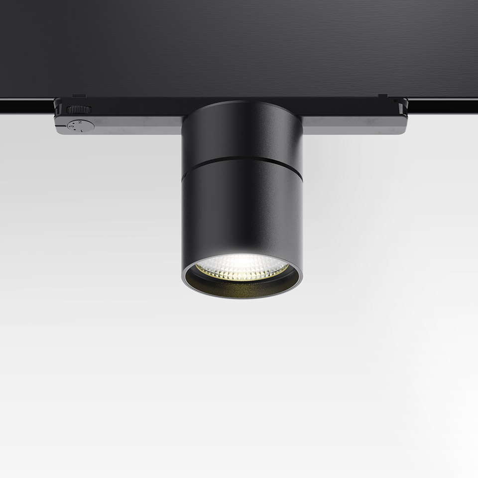 Artemide Hoy Spot 3-Phase Track: black cylindrical LED spotlight mounted on a three-phase track, directed downward - 2
