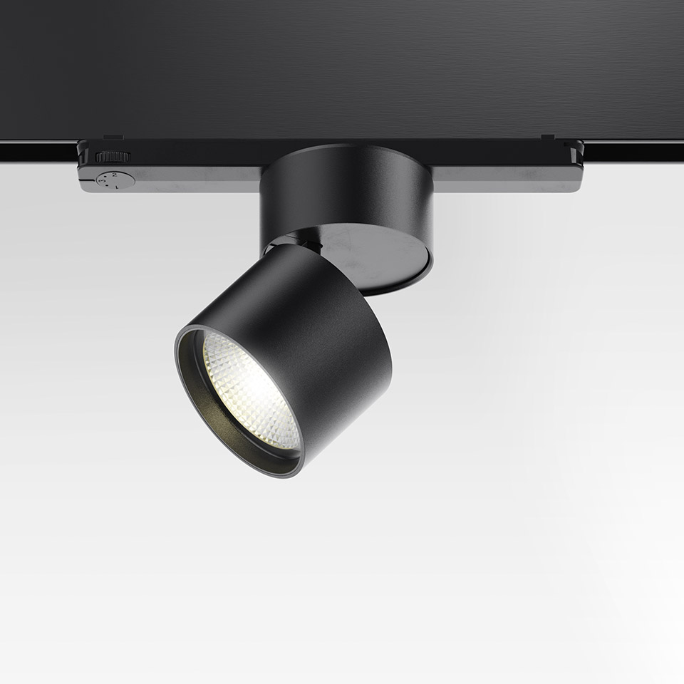 Artemide Hoy Spot 3-Phase Track: black adjustable LED spotlight mounted on a black three-phase track rail, tilted head