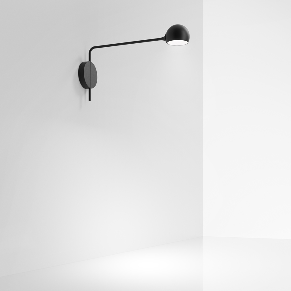 Artemide Ixa wall lamp in black, featuring a slender adjustable arm with a spherical head, mounted on a circular wall plate