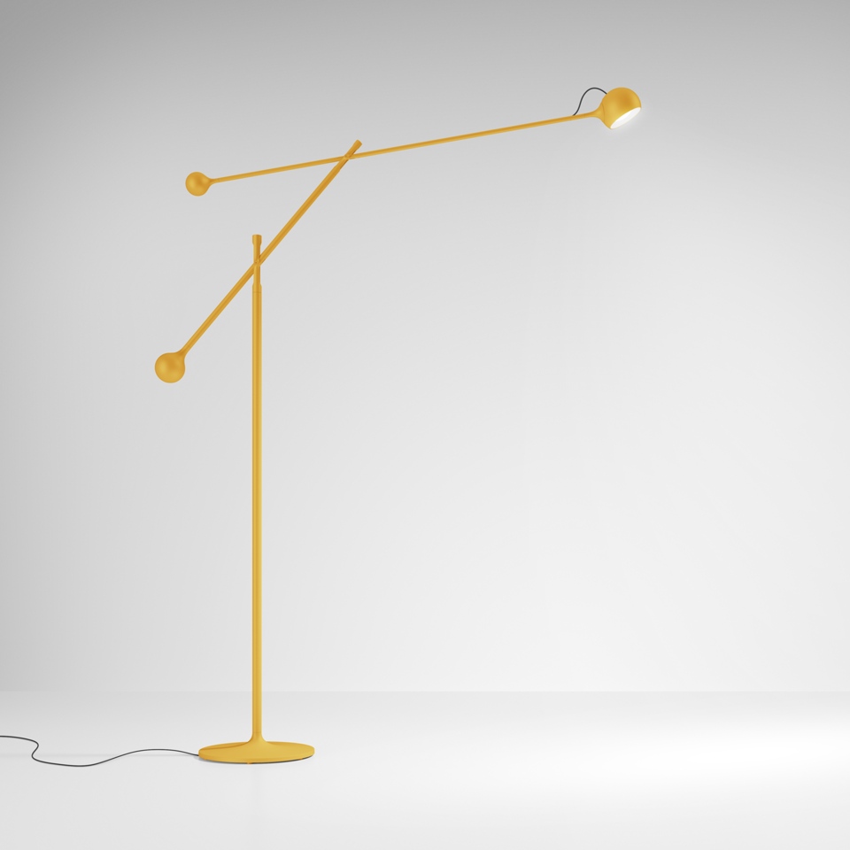 Artemide Ixa floor lamp in yellow, featuring an adjustable two-arm counterbalance design with a directional cylindrical head