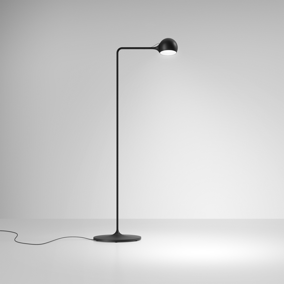 Artemide Ixa floor lamp in black, featuring a slender curved stem, round base, and adjustable spherical LED head