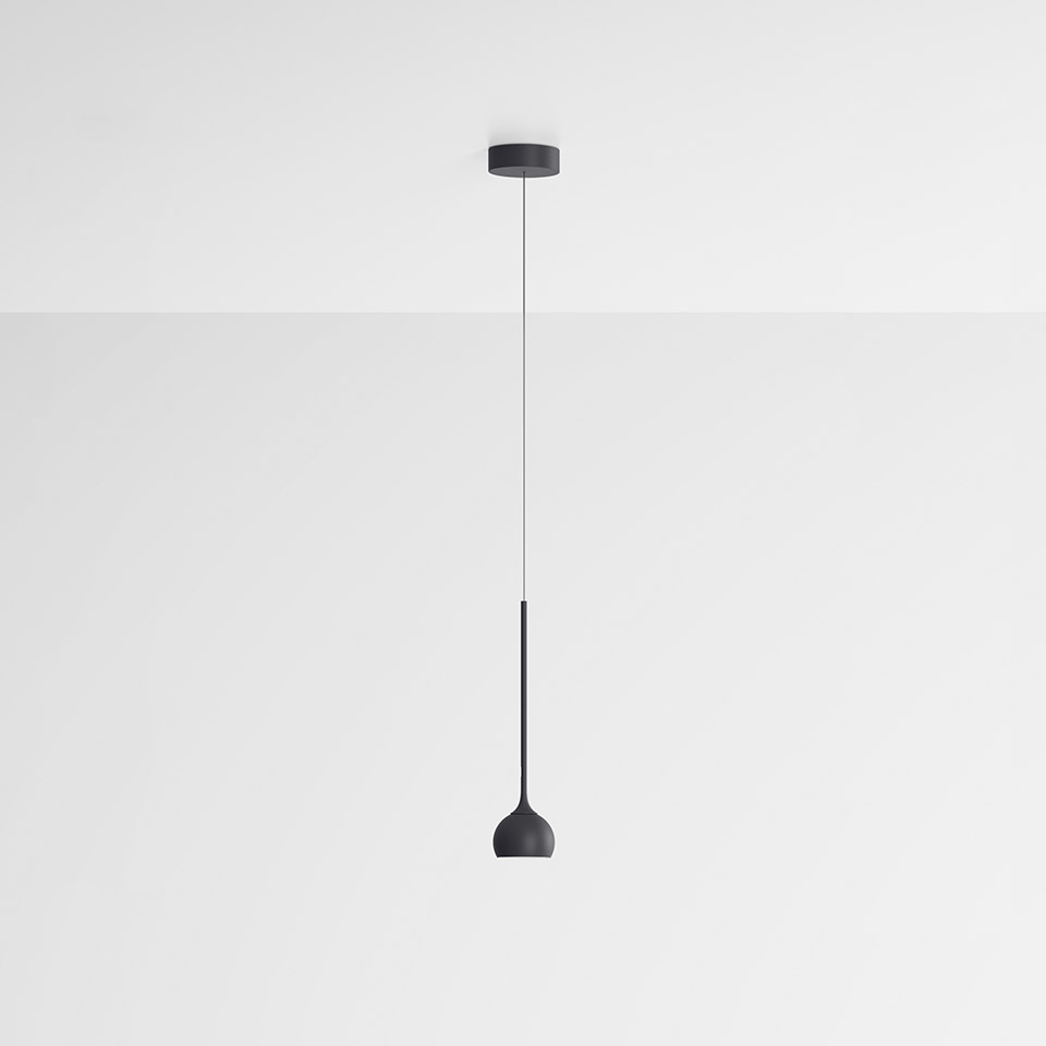 Artemide Ixa pendant lamp: sleek dark grey single pendant with slim stem and small dome shade, suspended from ceiling canopy