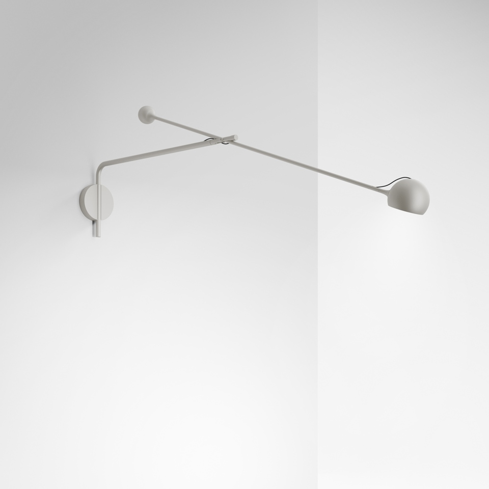 Artemide Ixa wall lamp: minimalist grey adjustable arm with spherical shade and counterbalance, mounted on a corner wall