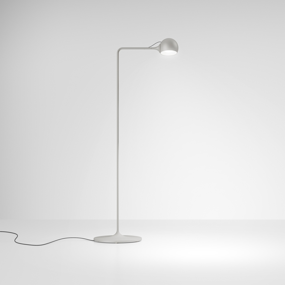 Artemide Ixa floor lamp in white, featuring a slender curved stem, circular base, and adjustable spherical LED head