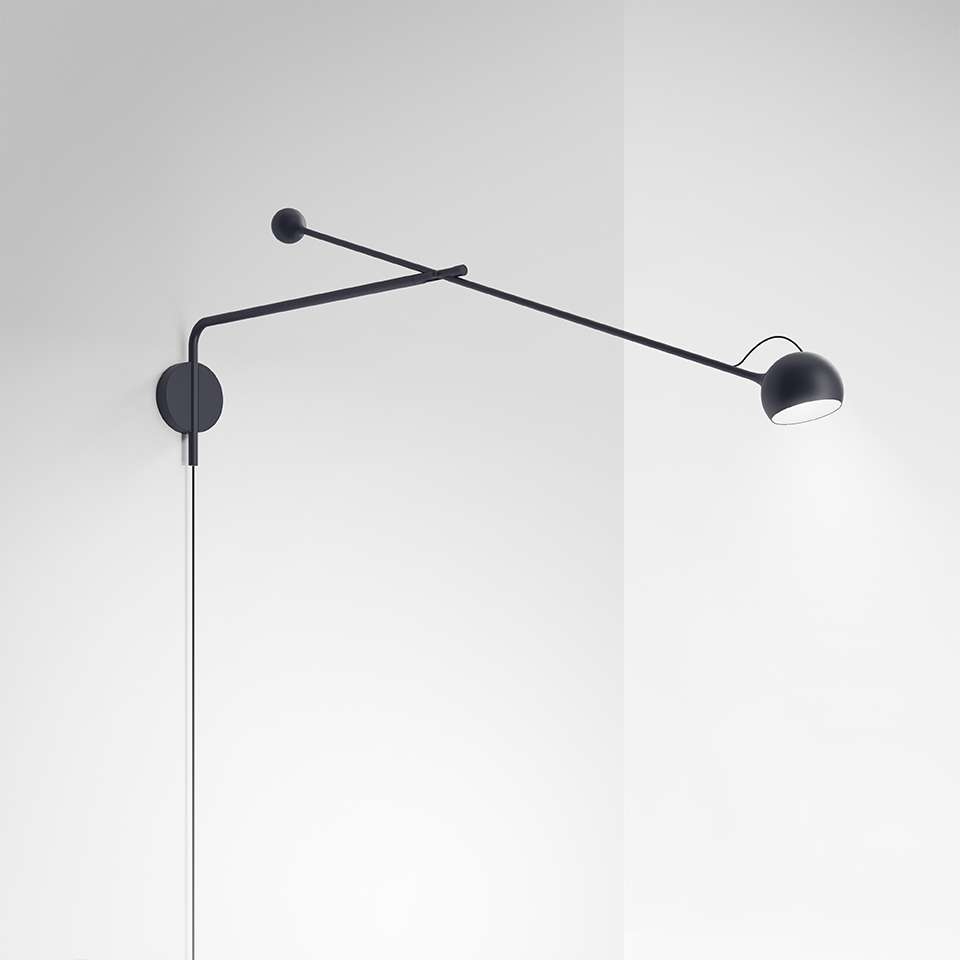 Artemide Ixa wall lamp in black, featuring a long adjustable arm with small counterweight and a compact directional bowl-shaped head