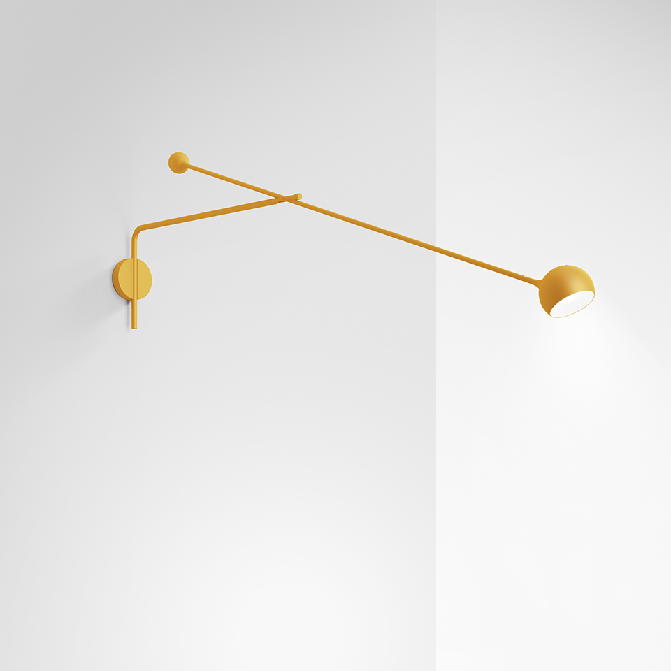 Artemide Ixa wall lamp in mustard yellow, featuring an adjustable two-arm articulated structure with a small directional spotlight head
