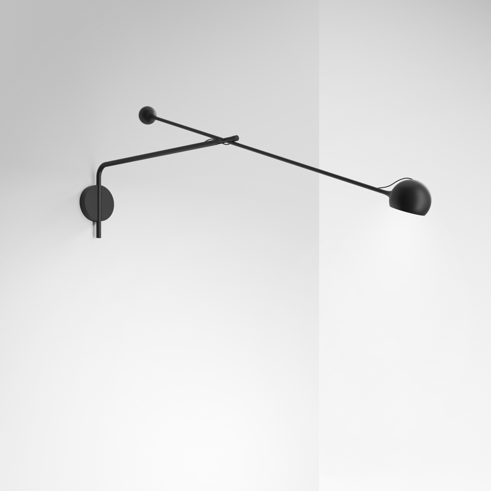 Artemide Ixa wall lamp in black, featuring a long adjustable arm with spherical head and counterbalance rod, mounted on a round wall plate
