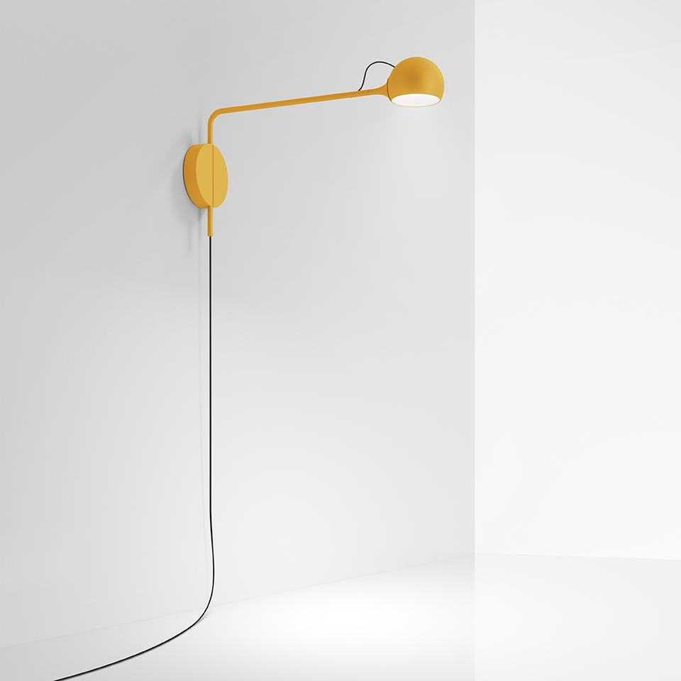 Artemide Ixa wall lamp in yellow, featuring an adjustable arm, spherical head, oval wall mount, and black cord