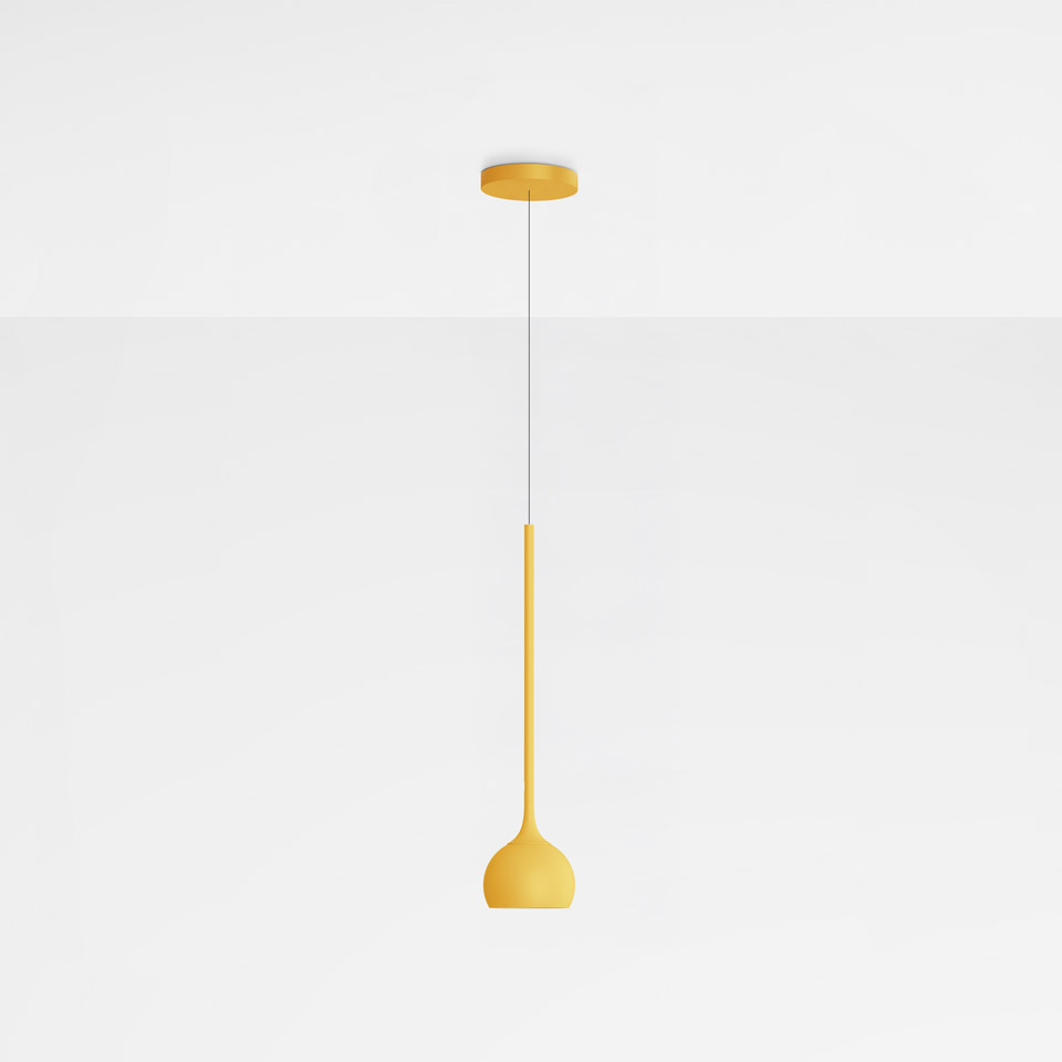 Artemide Ixa pendant lamp in yellow, featuring a slim elongated stem and rounded bell-shaped shade, suspended from a ceiling canopy.
