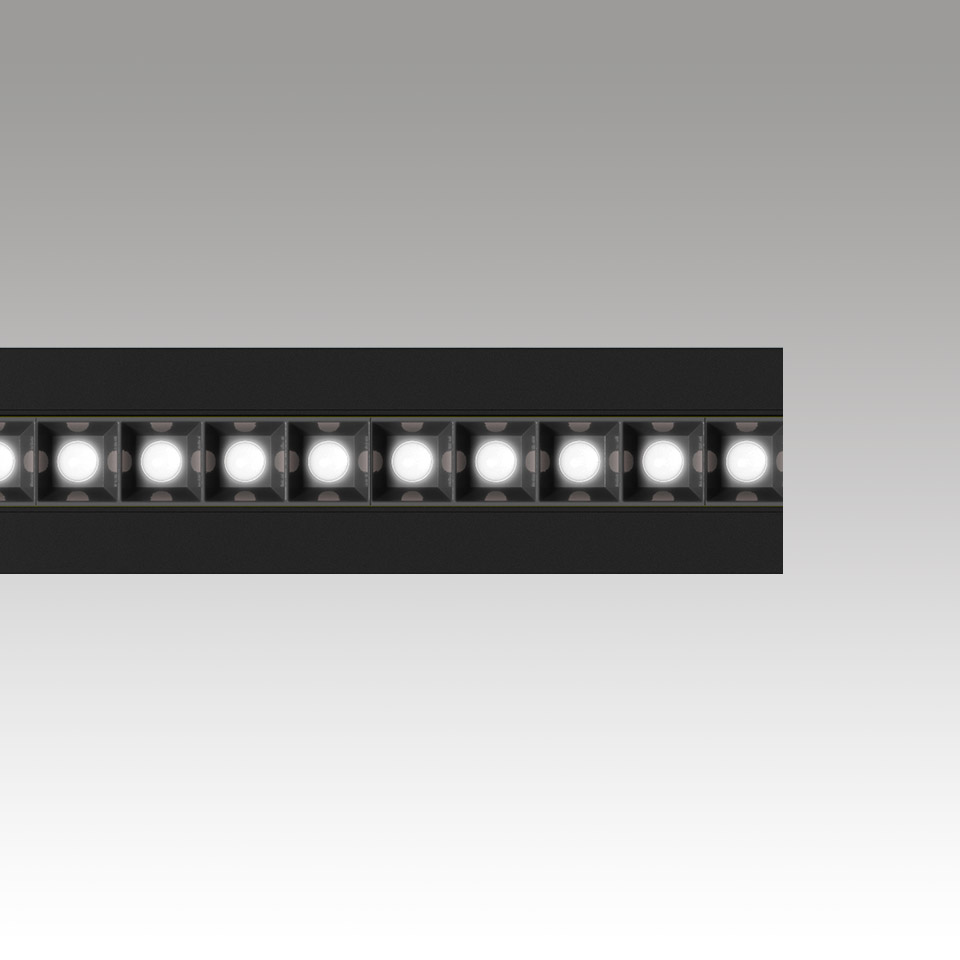 Artemide Katà Métron linear LED light fixture in black, showing a row of individual square LED modules emitting bright white light