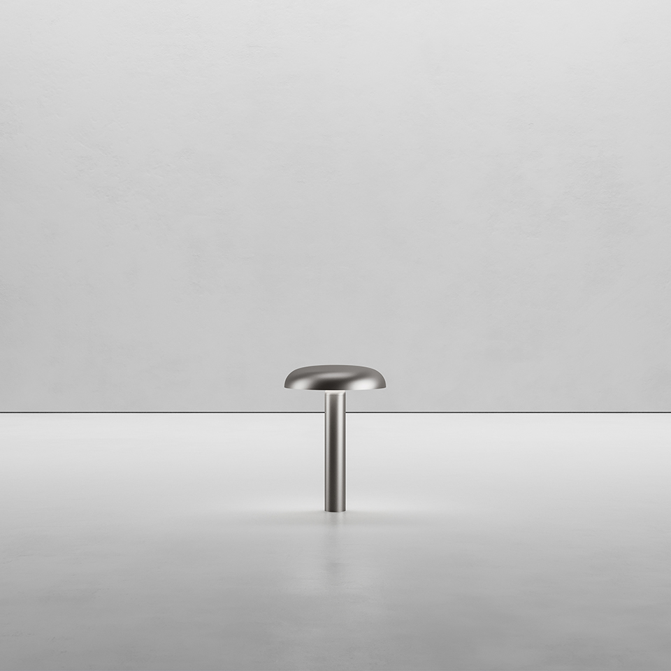 Artemide Knop table lamp in brushed steel, featuring a slim cylindrical stem topped with a flat mushroom-shaped diffuser
