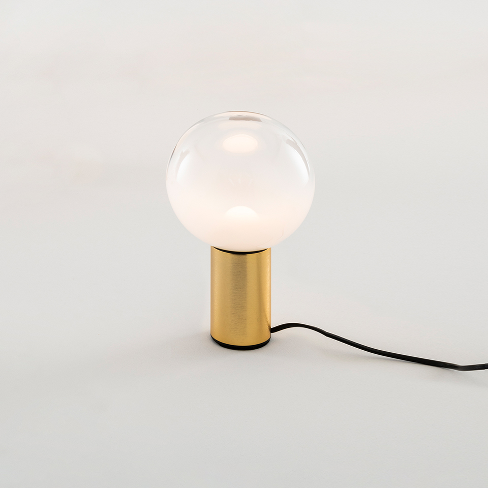 Artemide Laguna Tavolo table lamp: spherical clear glass globe diffuser on a brushed gold cylindrical base with black cord