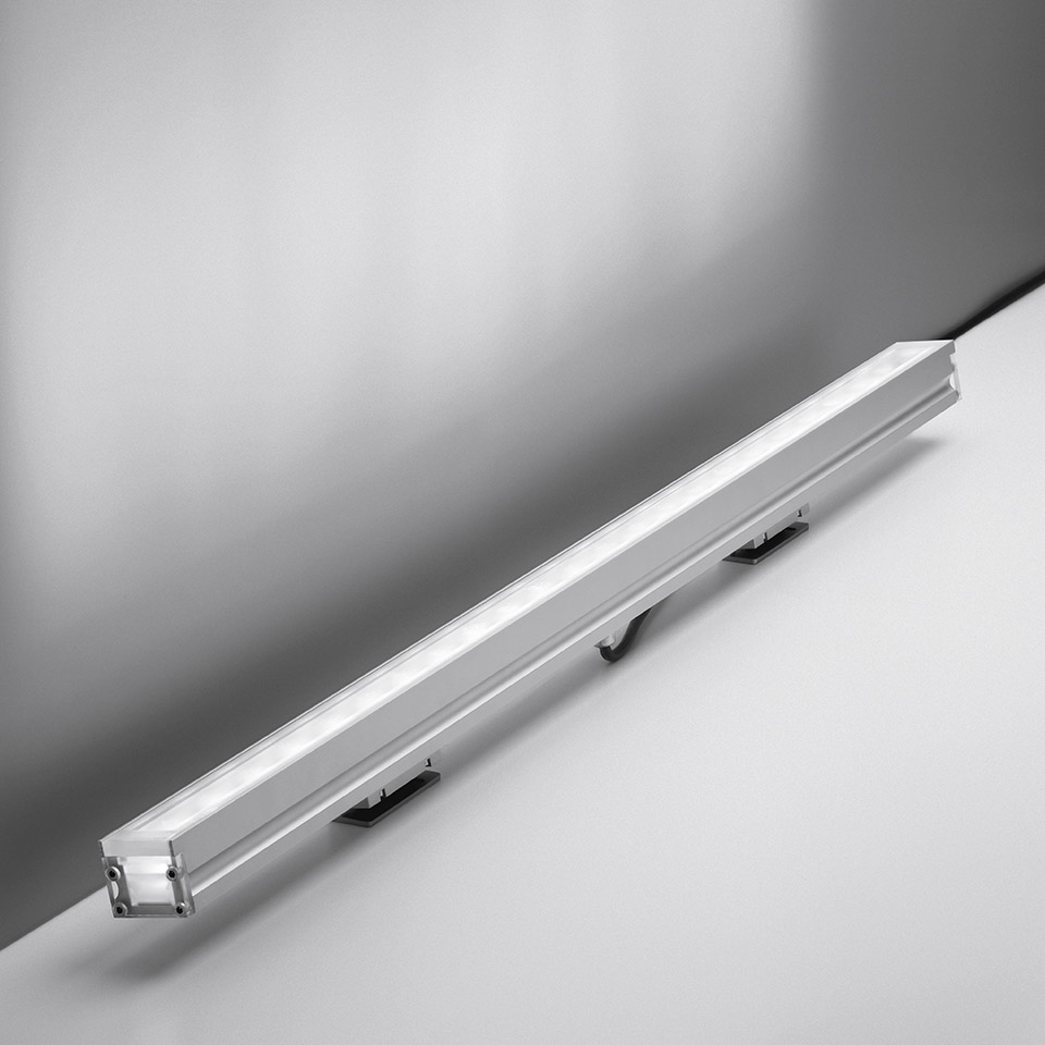 Artemide LineaLed Wallwasher: slim elongated aluminum LED bar with diffused light strip and mounting brackets, angled view