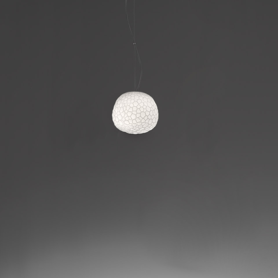 Artemide Meteorite pendant lamp: white spherical diffuser with organic cellular texture, suspended by thin cables