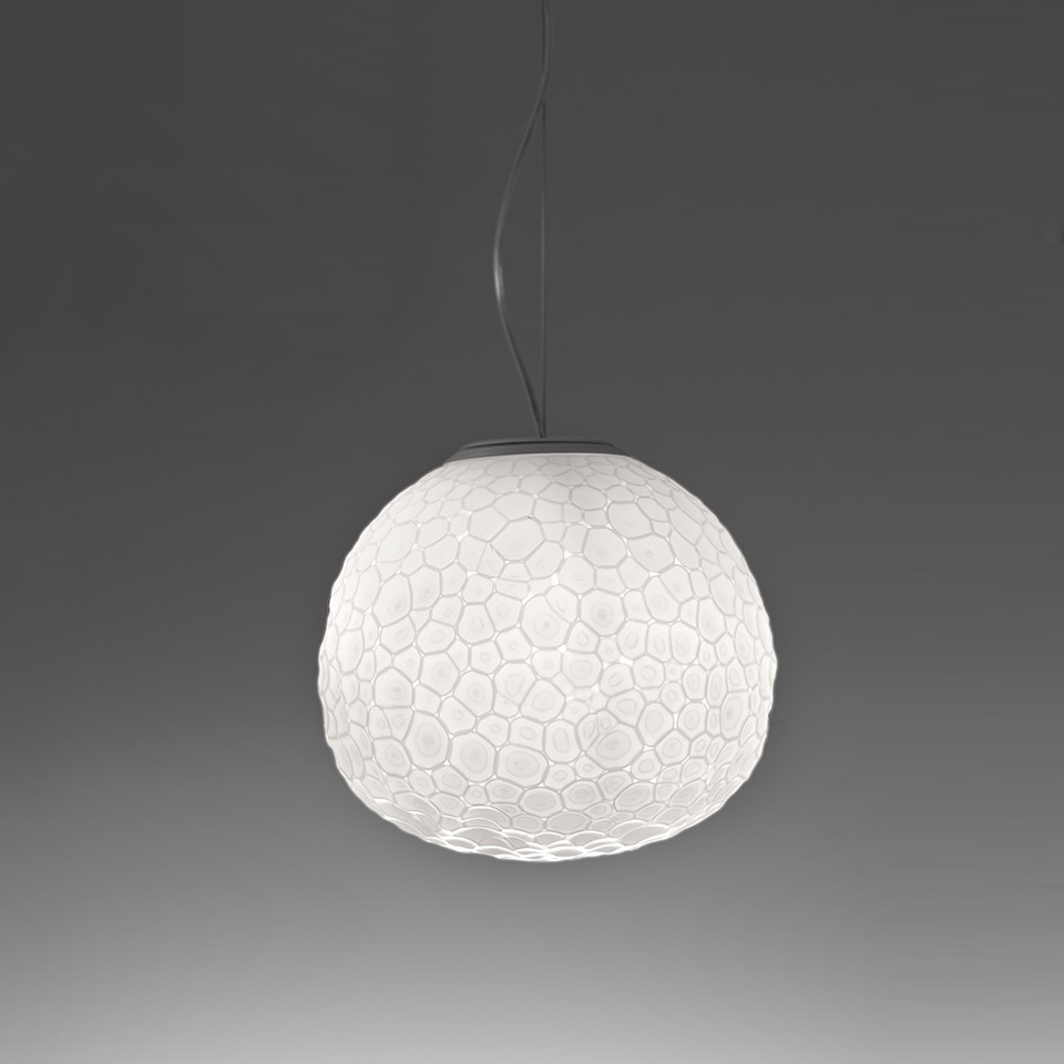 Artemide Meteorite pendant lamp: white blown glass globe with organic cellular texture, suspended by a dark cable