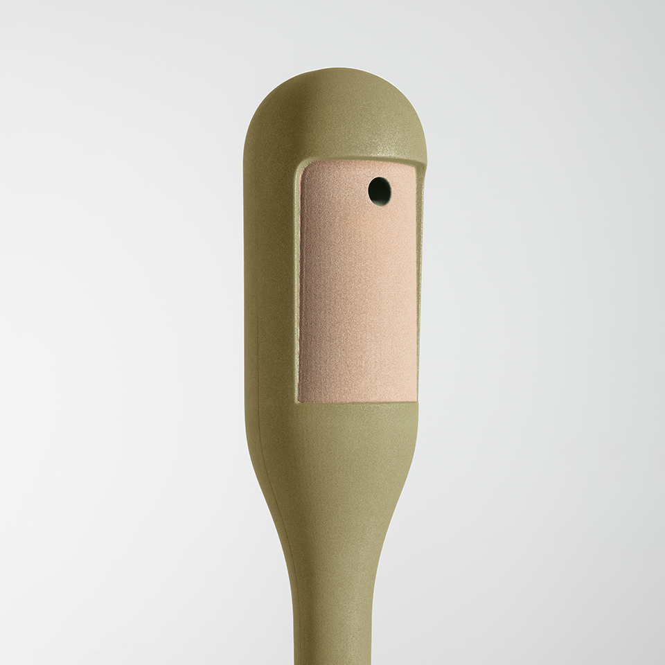Artemide Needoo floor lamp top detail: olive green body with rounded head and rectangular leather patch with single black button