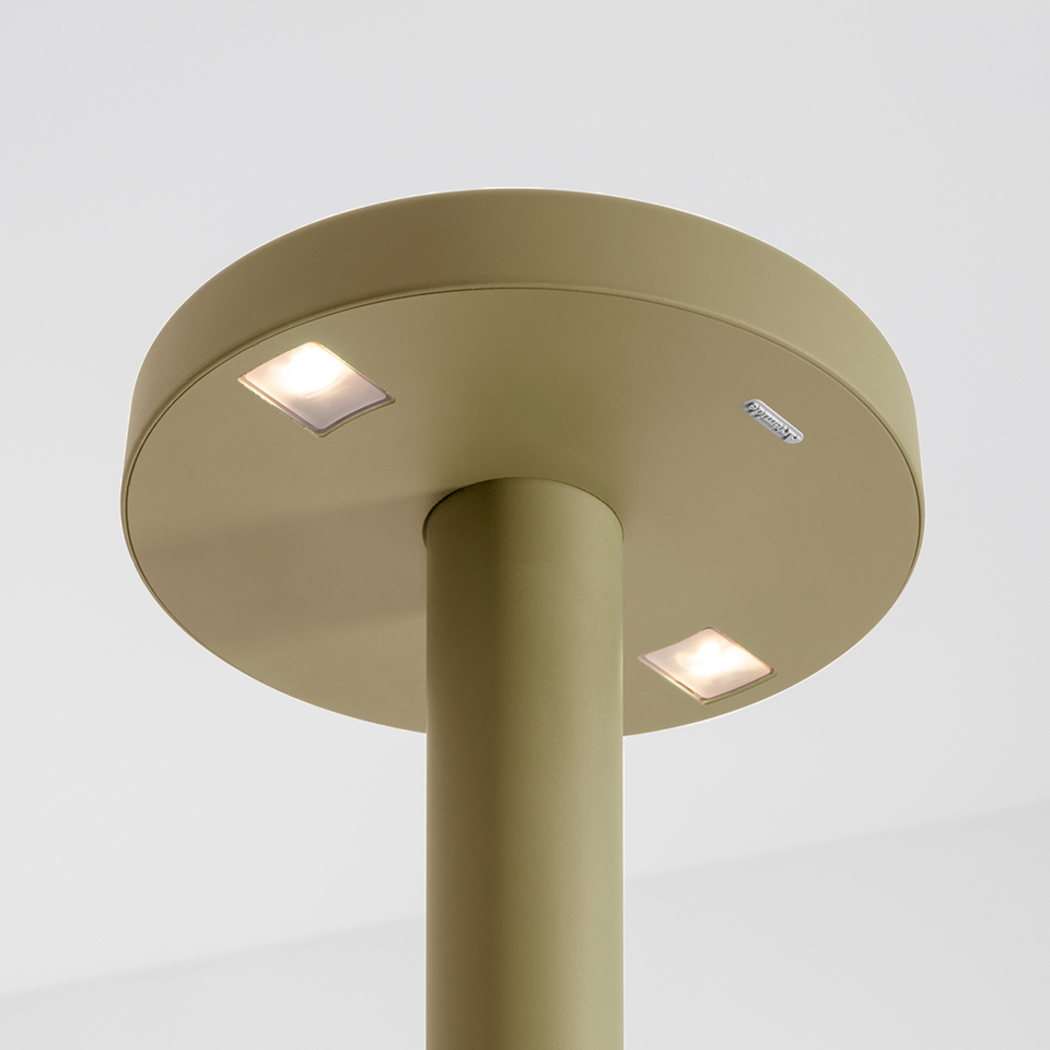 Artemide Needoo table lamp, sage green cylindrical stem with circular top featuring two recessed square LED lights