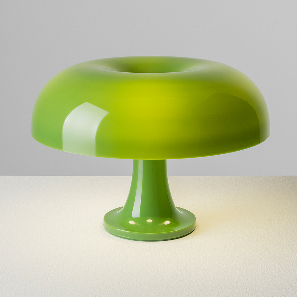 Artemide Nessino table lamp in green, featuring a glossy mushroom-shaped shade and a slender pedestal base on a white surface - 2