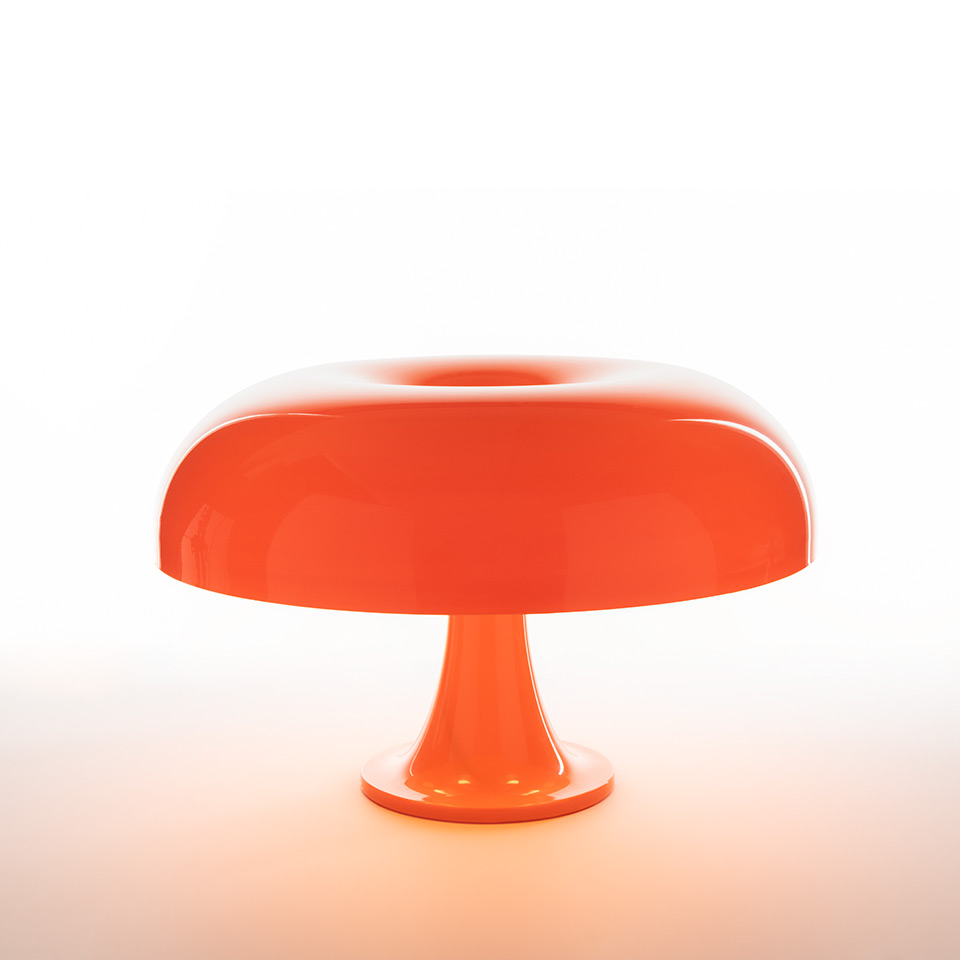 Artemide Nesso table lamp in glossy orange, featuring iconic mushroom-shaped shade with open top on a trumpet base, emitting warm light