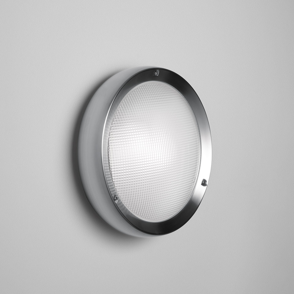 Artemide Niki wall/ceiling lamp: round fixture with brushed steel ring and white prismatic diffuser, mounted on wall