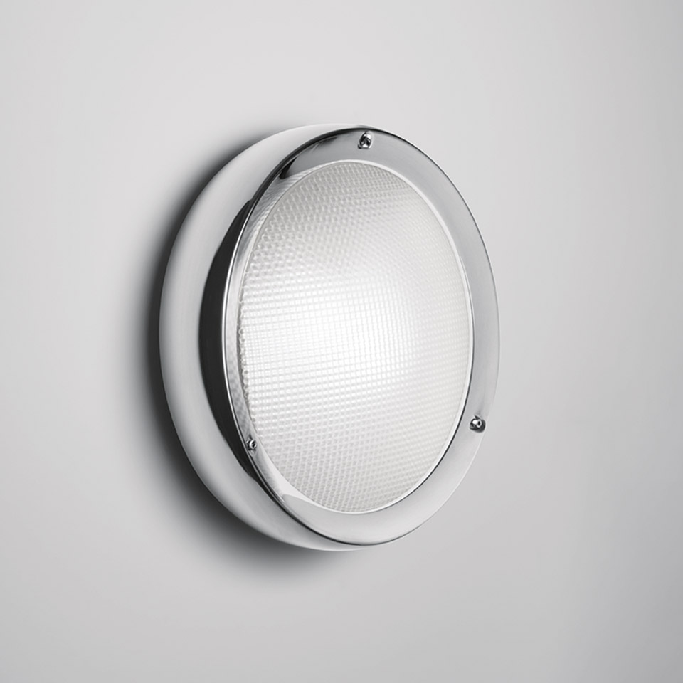 Artemide Niki wall/ceiling lamp: round white body with chrome ring, textured prismatic glass diffuser, mounted on wall