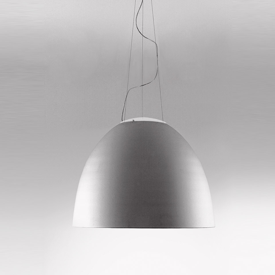 Artemide Nur 1618 pendant lamp with large matte aluminum dome shade suspended by thin cables on a neutral background