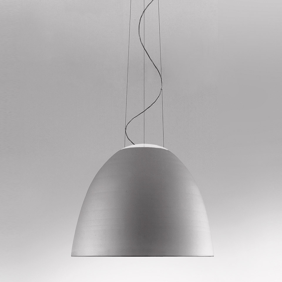 Artemide Nur pendant lamp with brushed aluminum dome shade suspended by thin cables and a twisted cord on gray background