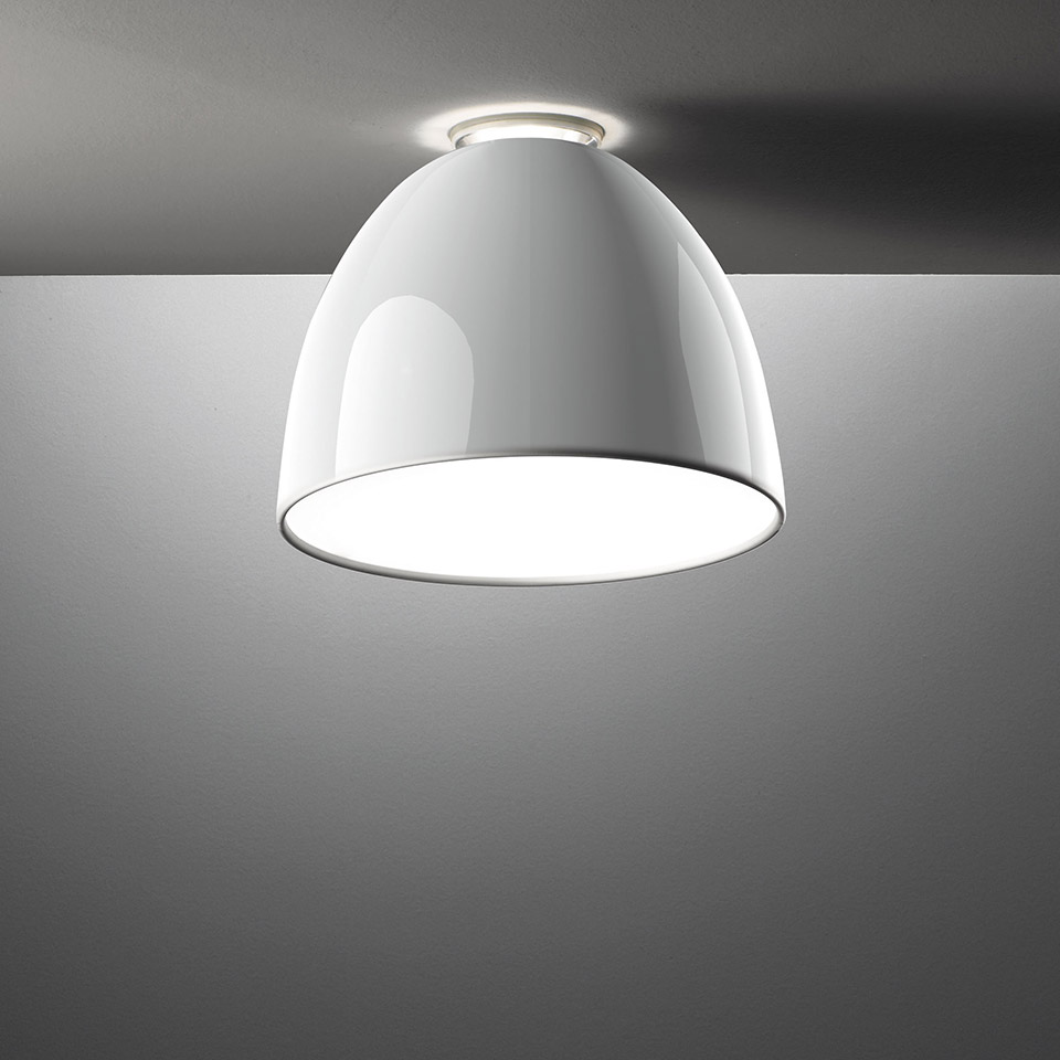 Artemide Nur Mini Gloss ceiling lamp with glossy white dome shade, flush-mounted, emitting soft downward light