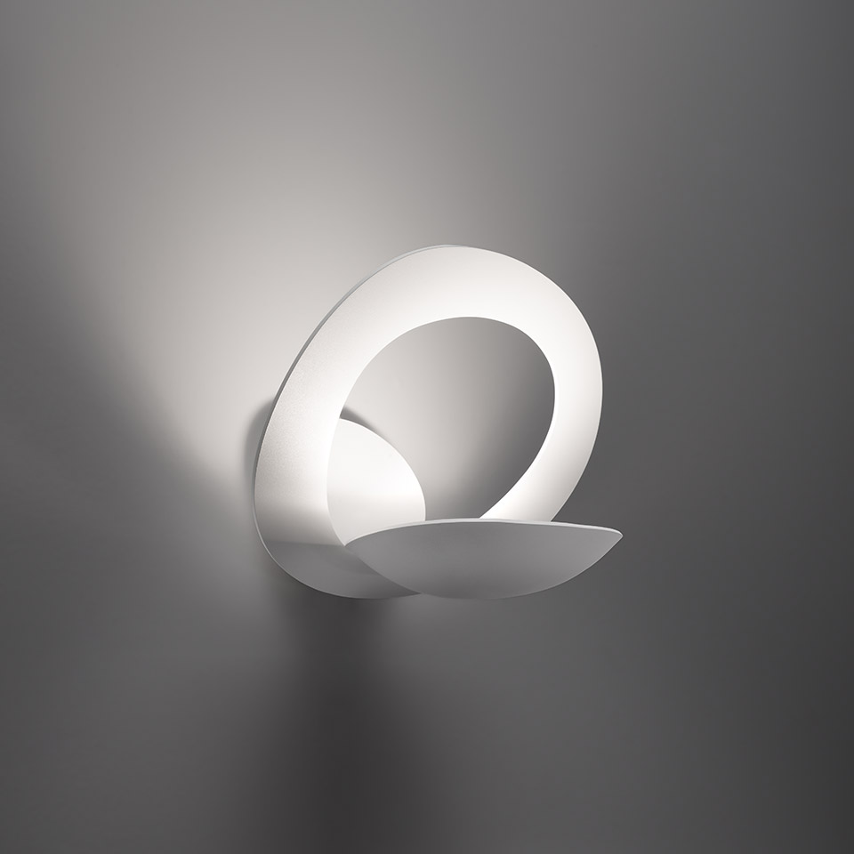 Artemide Pirce Parete wall lamp: sculptural white LED fixture with a curved ribbon-like form emitting soft ambient light