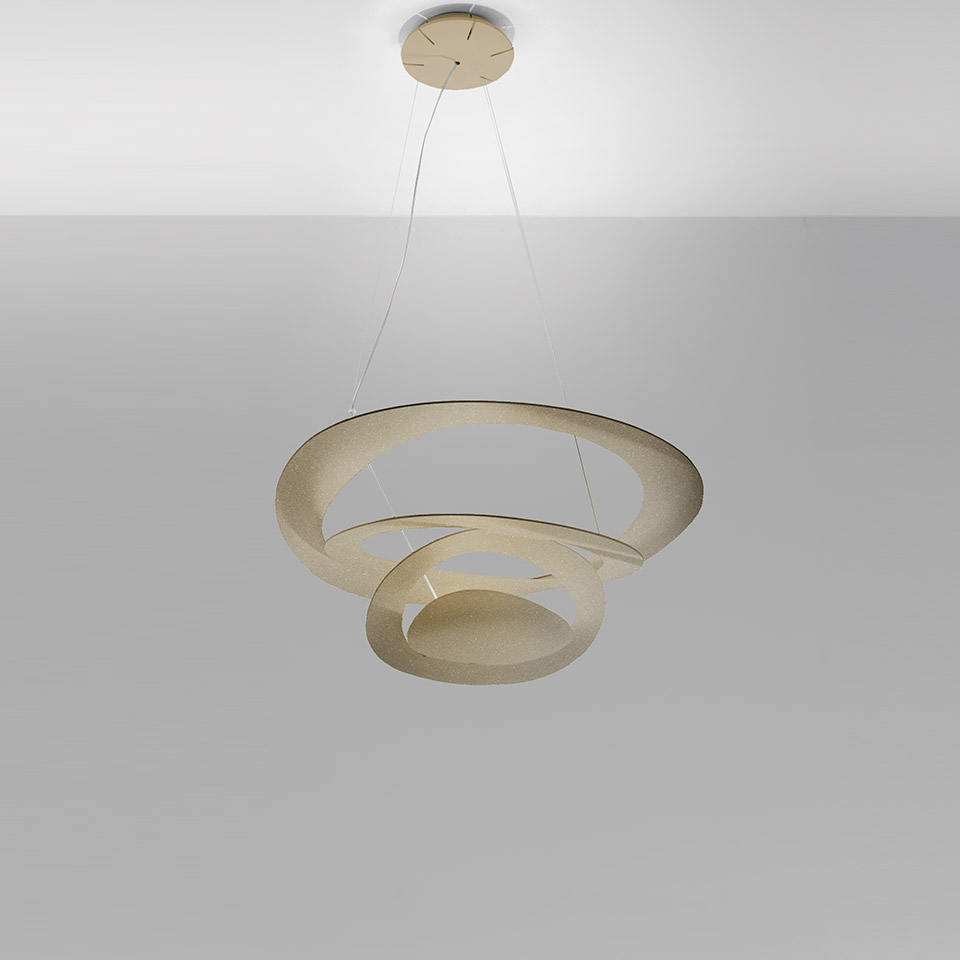 Artemide Pirce pendant lamp: gold spiral-shaped aluminum shade forming two concentric rings, suspended by thin cables