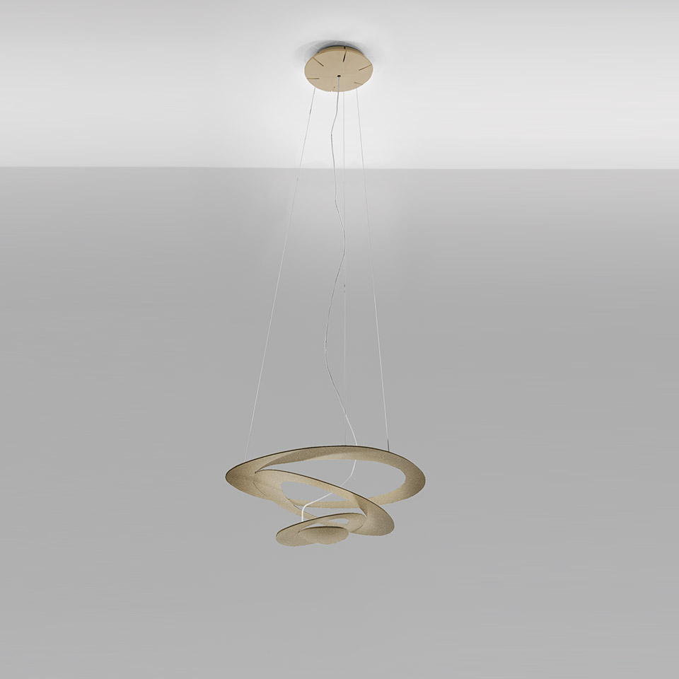 Artemide Pirce pendant lamp in gold finish, featuring a sculptural spiral aluminum shade suspended by thin cables from a ceiling canopy