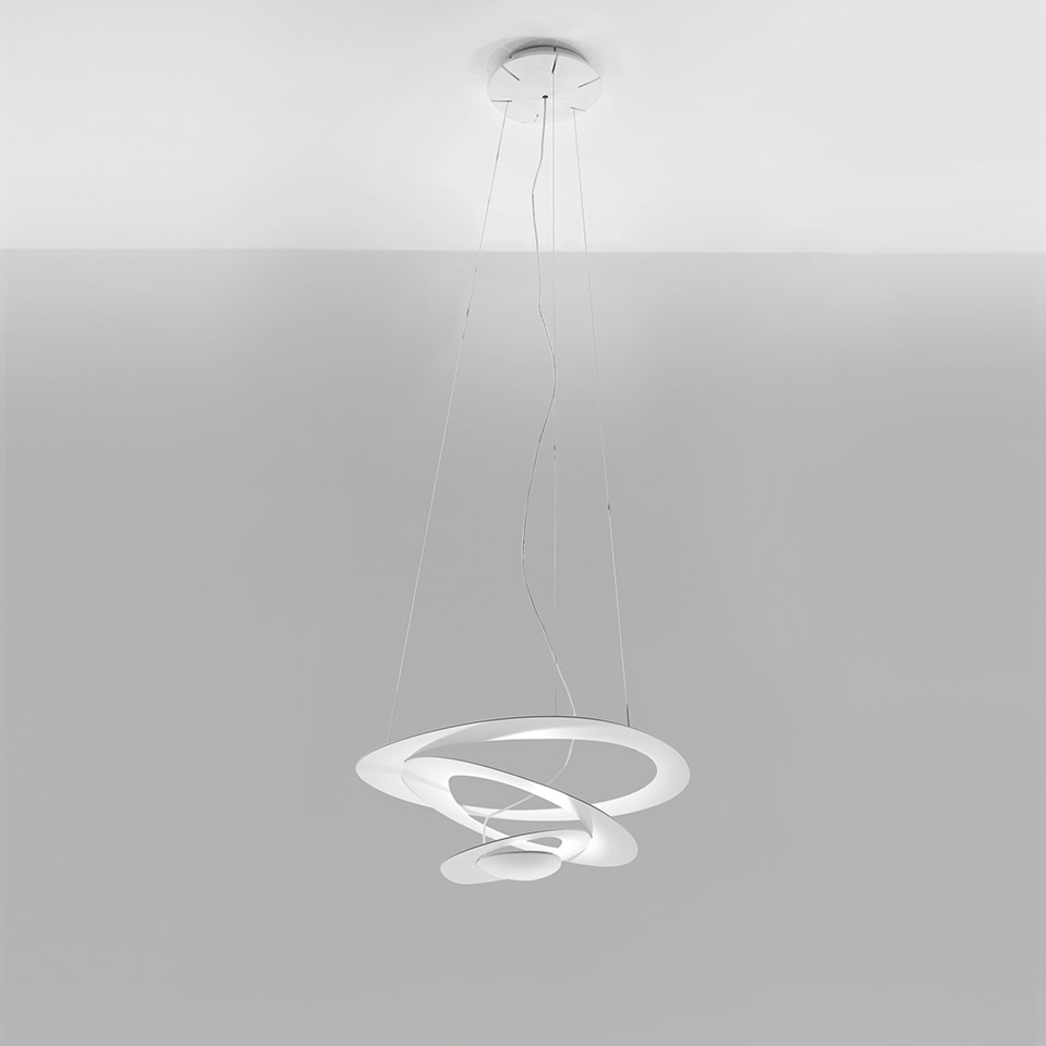 Artemide Pirce pendant lamp in white, featuring an elegant spiral-shaped diffuser suspended from the ceiling by thin cables
