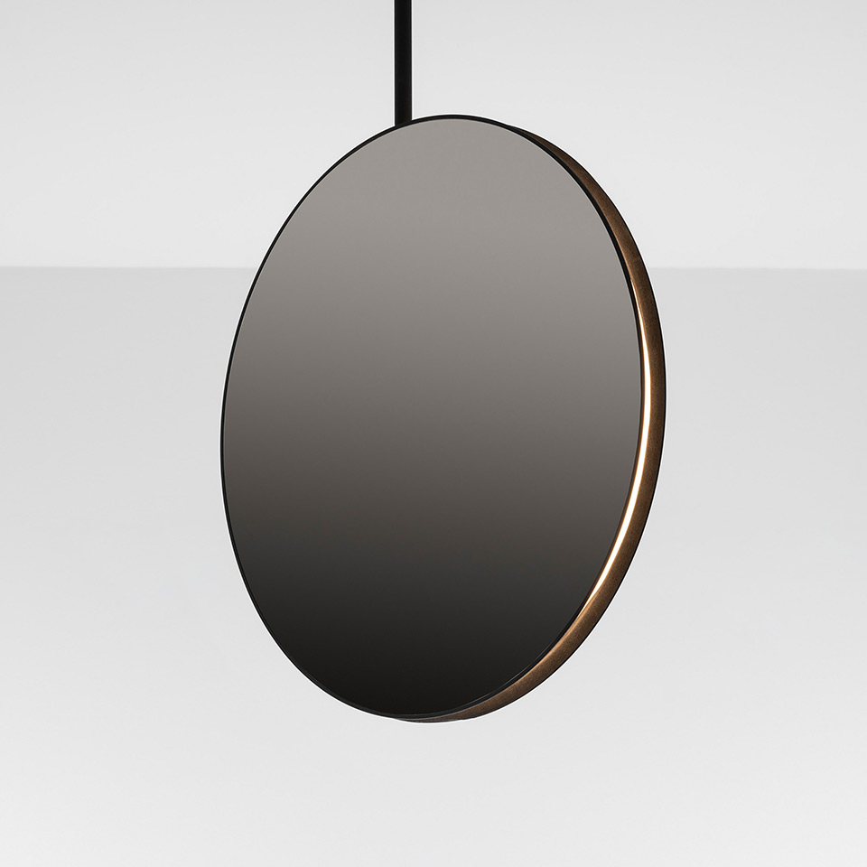 Artemide Se|eS pendant lamp: circular dark smoked disc with warm LED light along bronze inner edge, suspended by black cord