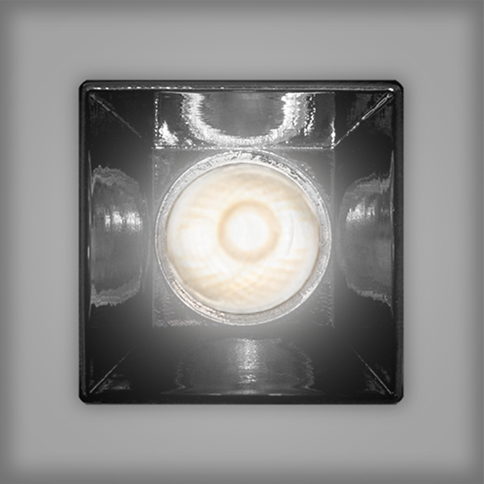 Artemide Sharp recessed spotlight, square black frame with circular LED source emitting warm white light, viewed from below
