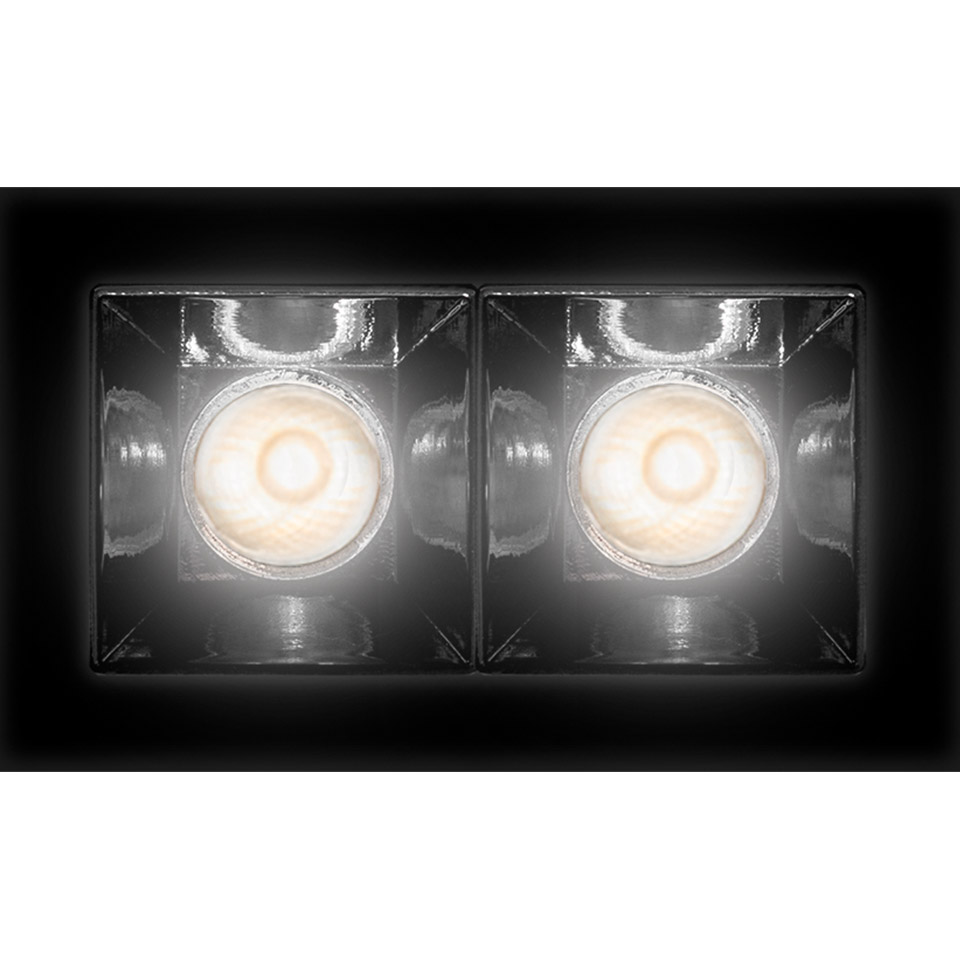 Artemide Sharp recessed ceiling light with two square LED modules in black frame, emitting warm white light downward.