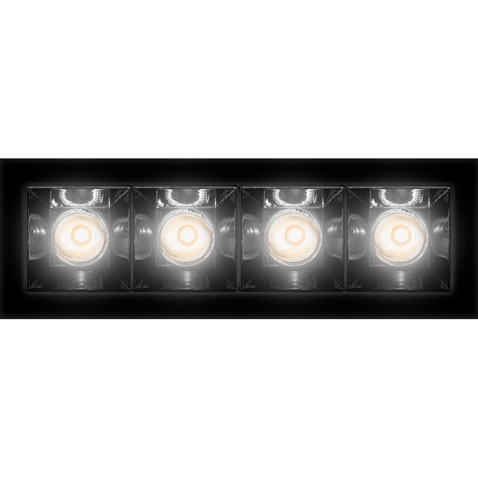 Artemide Sharp recessed ceiling light with four square LED modules in a black rectangular frame, emitting warm white light.