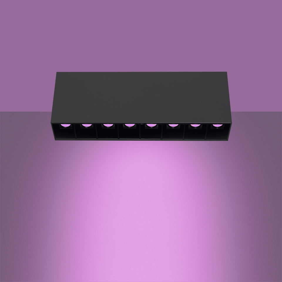 Artemide Sharp SMD ceiling light, black rectangular fixture with 7 LED modules emitting purple-pink light downward